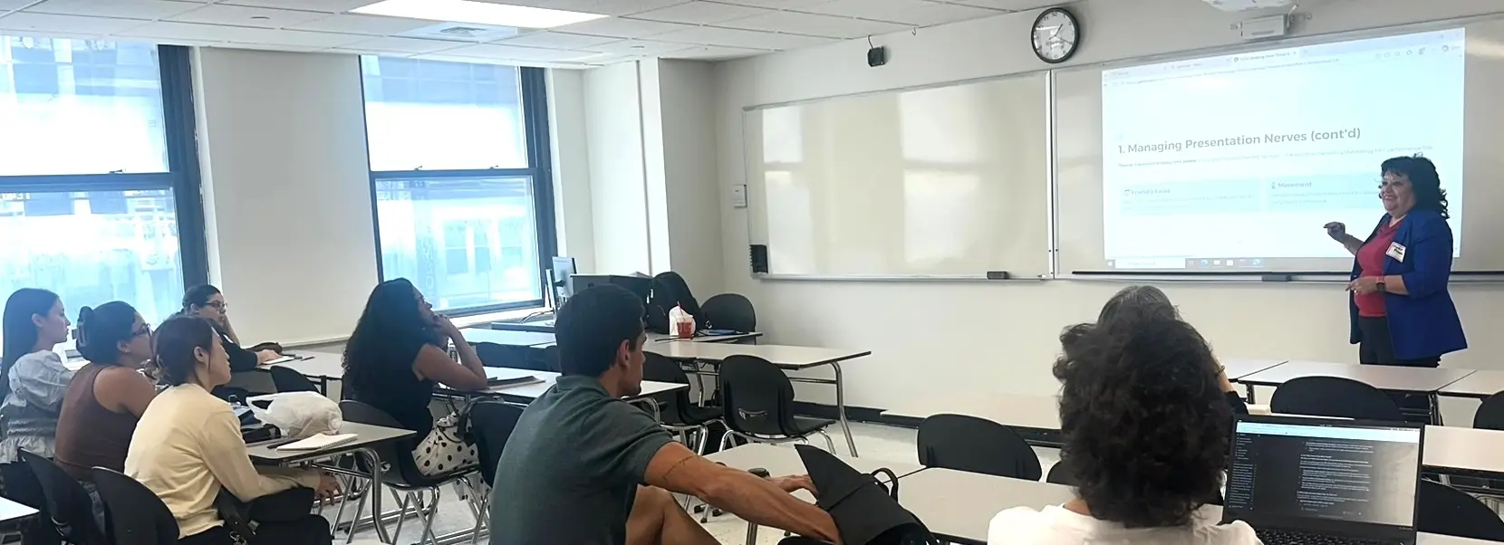 Rennert students attending an AI and public speaking workshop led by a Berkeley College professional in a New York City classroom.