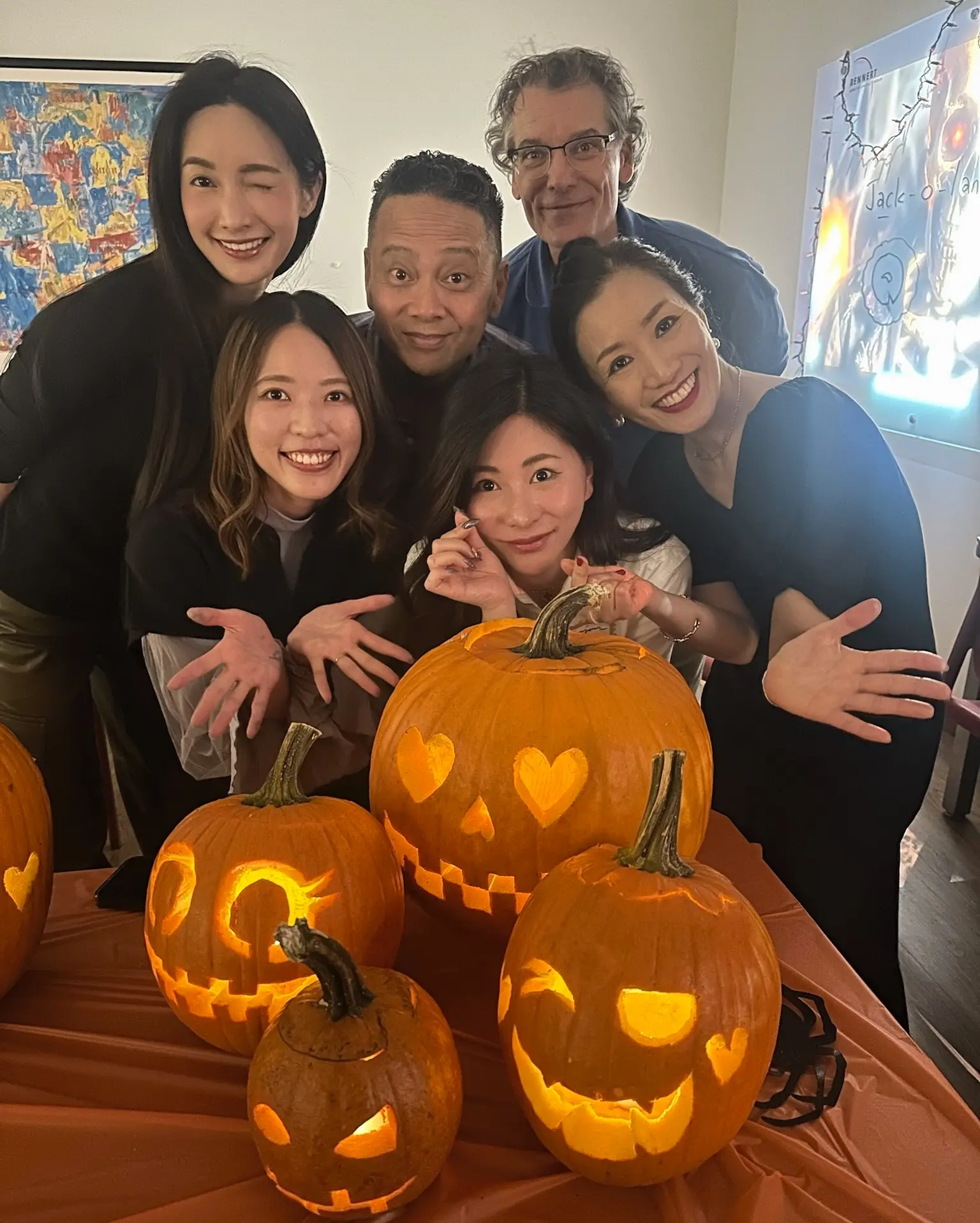 Rennert students and staff posing with carved Halloween pumpkins during a fall activity in New York City.