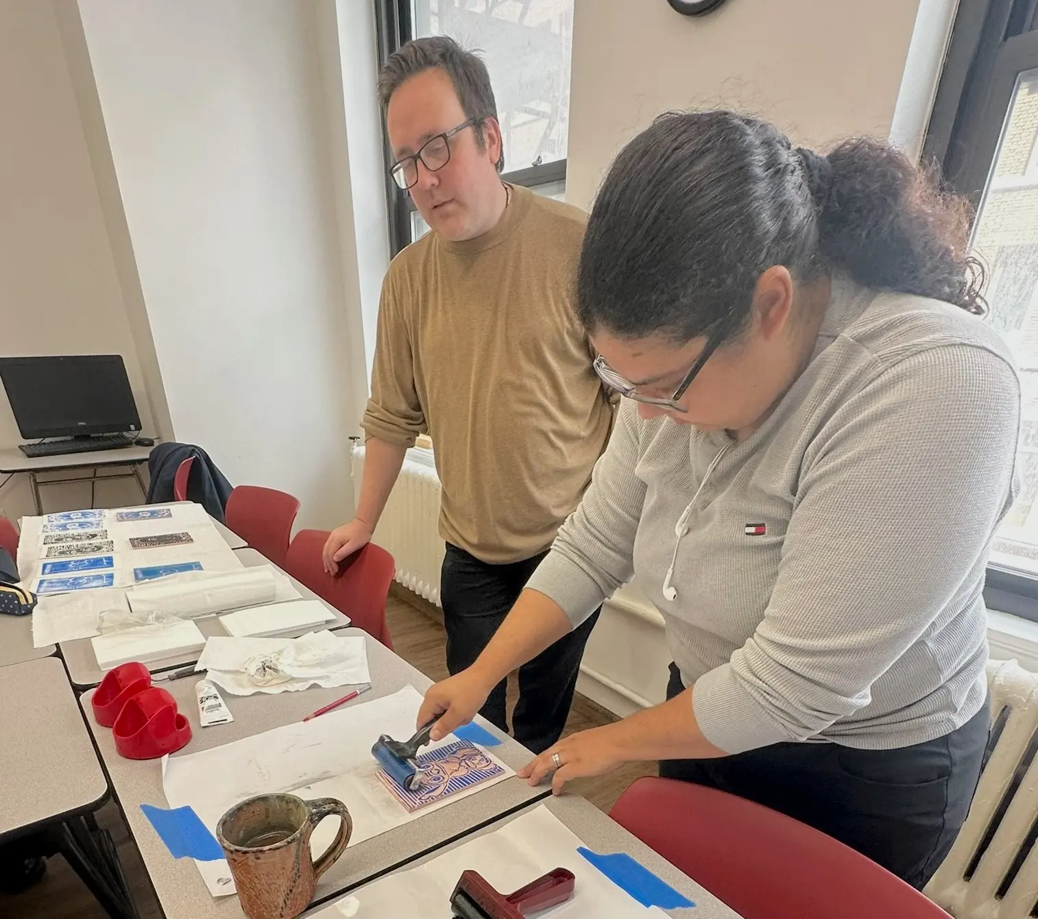 Rennert student creating a print during a hands-on printmaking workshop led by a Berkeley College professor.