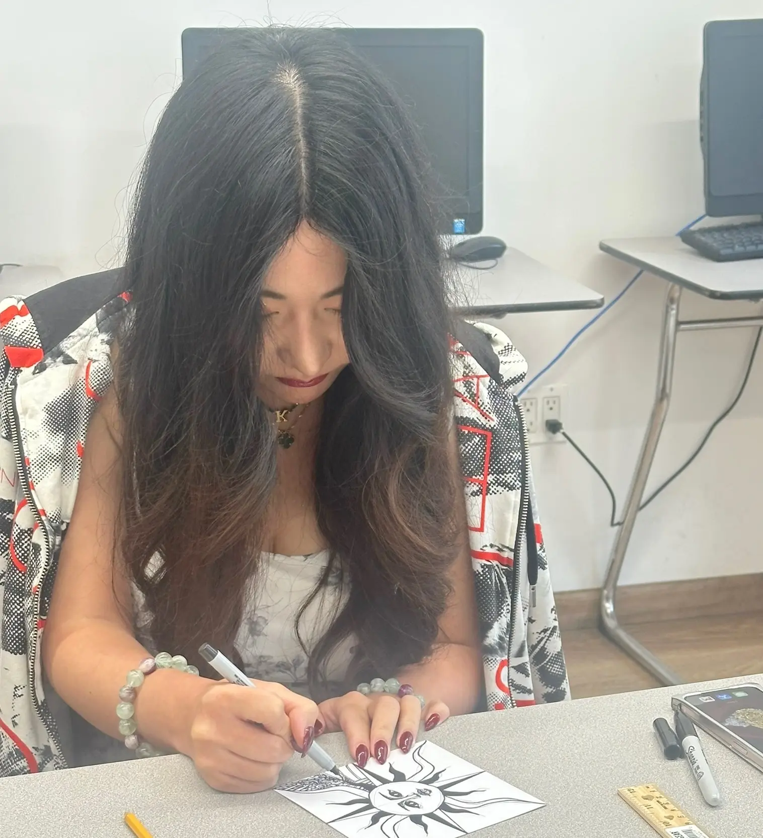 Rennert student creating a Zentangle drawing during a hands-on graphic design workshop in New York City.