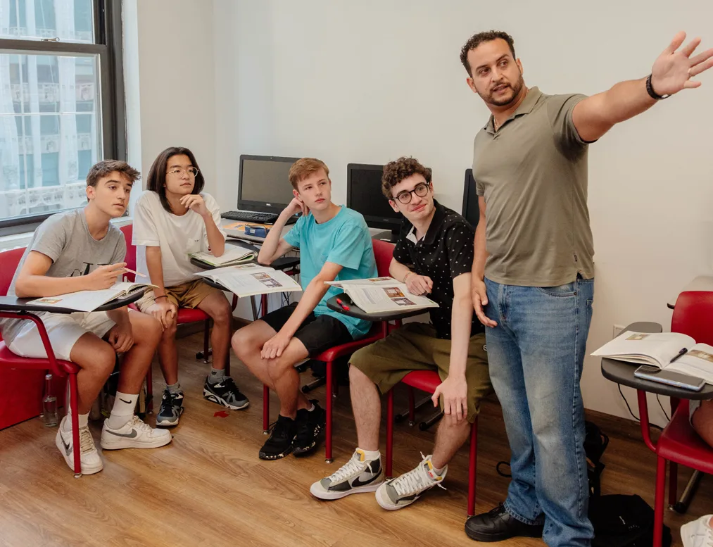 Teens in a Rennert New York English summer class, listening to their instructor during a classroom lesson.